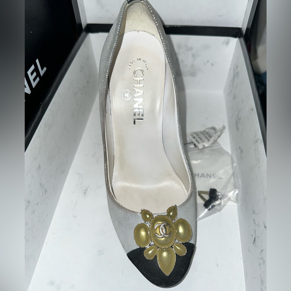 Gently loved Chanel silver/black trim with gold accents on toe. Size 37.5